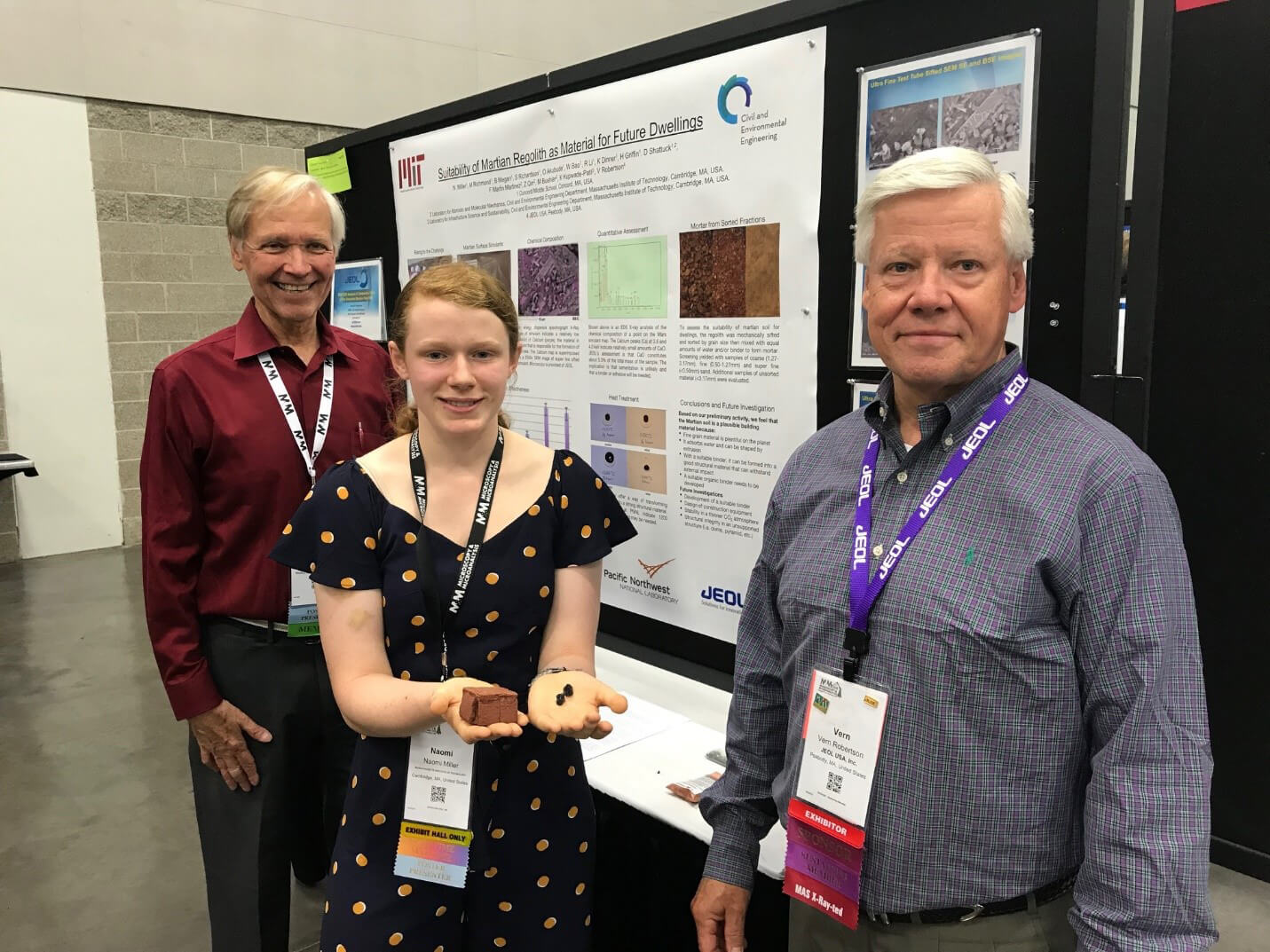 Naomi Miller holds sample of regolith and presented the findings of the CCMS-MIT research group at M&M 2019. Also in photo are her 8th grade teacher, Doug Shattuck (left) and JEOL collaborator Vern Robertson (right).
