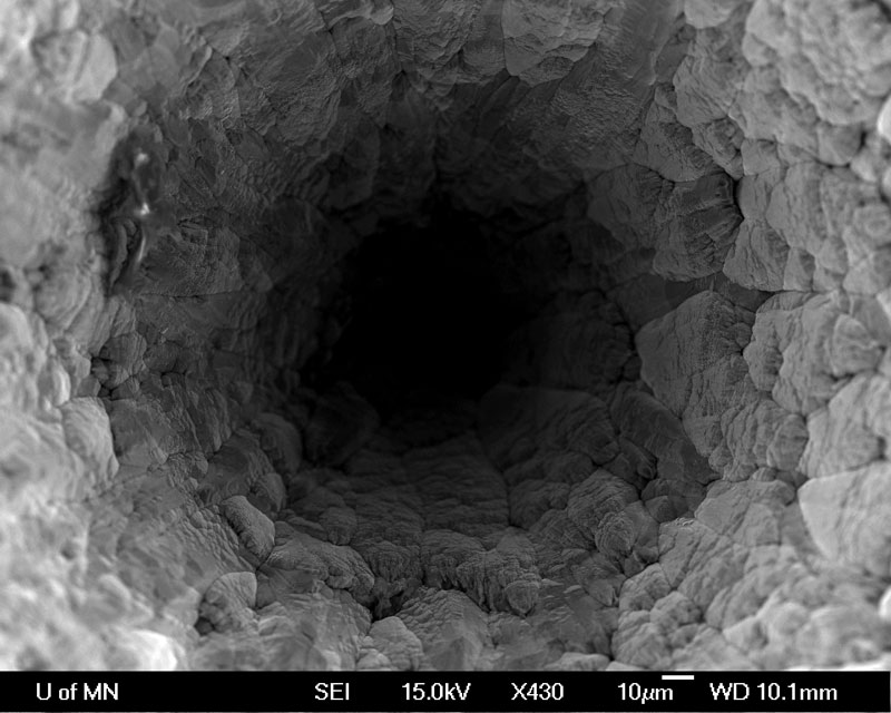 Subject: Hole in a dead Al cathode from an ion gun used in sample coater; Credit: Nicholas Seaton - Univ. of Minnesota; Method/Instrument: SE, JSM-6500F Field Emission SEM