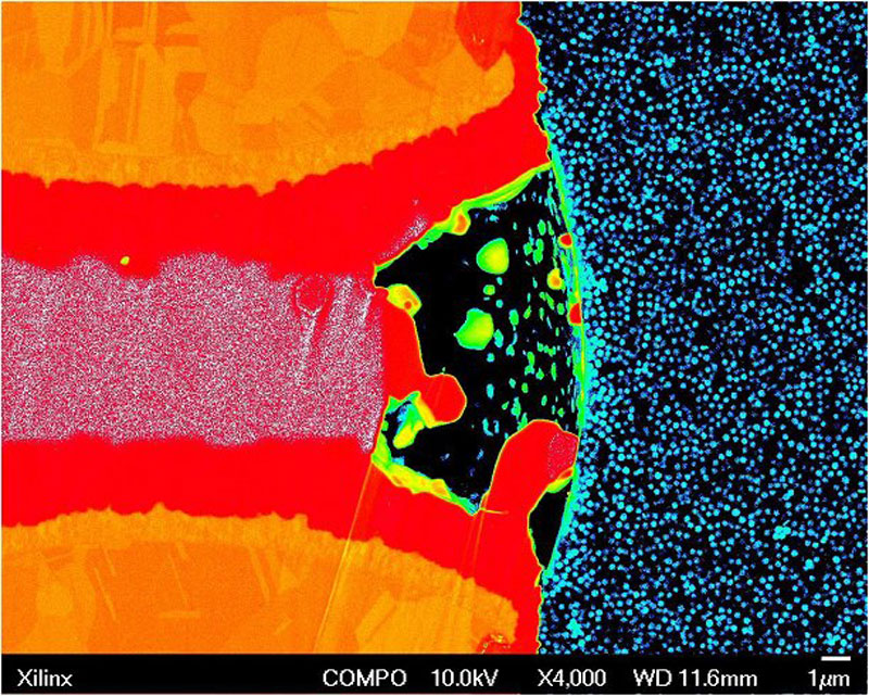 Subject: "Cross-section of an astronaut's helmet as he stands on the moon gazing out into the cosmos." SEM image of cross-section of microbump with void in solder joint; Credit: Douglas Hamilton, Xilinx; Method/Instrument: JSM-6700F Field Emission SEM