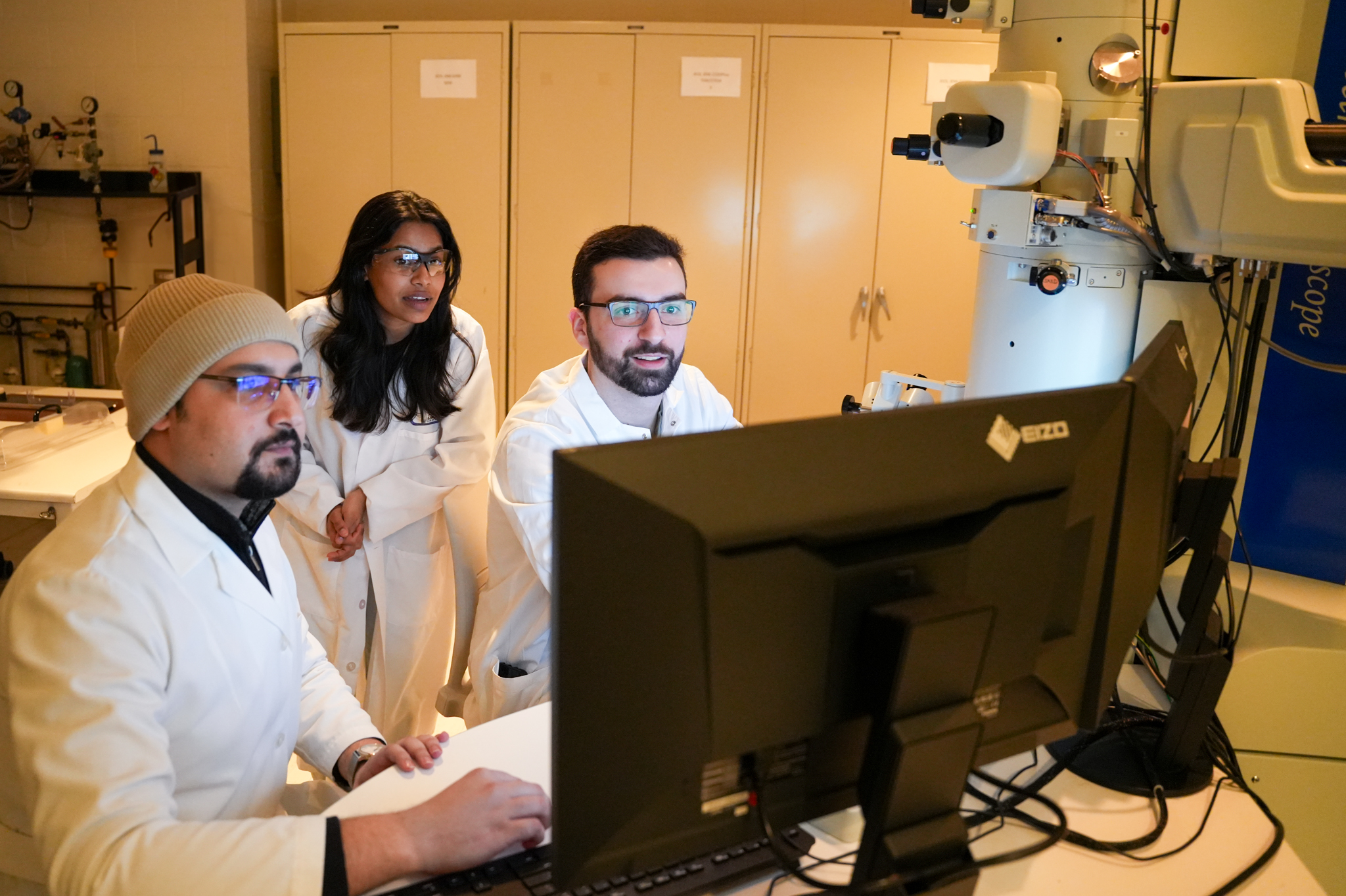 Mohammed Bagheri Kashani, Porvajja Nagarajan, and Anthony Branco viewing a sample