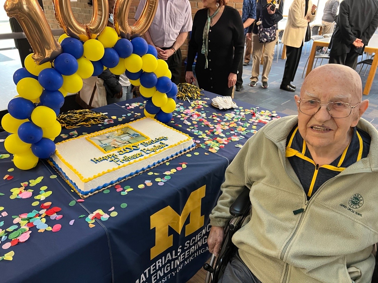 Prof. Wil Bigelow honored with a special cake and the blue and gold theme of University of Michigan